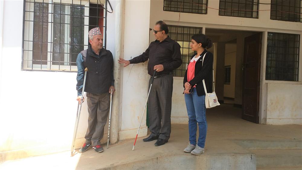 A person with mobility disabilities and a person with visual impairments accessing the ramp.