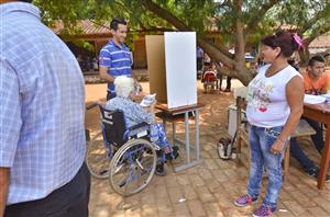 Person with physical disability voting.
