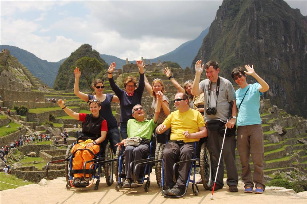 A group picture of people with different disabilities by the Machu Picchu site.
