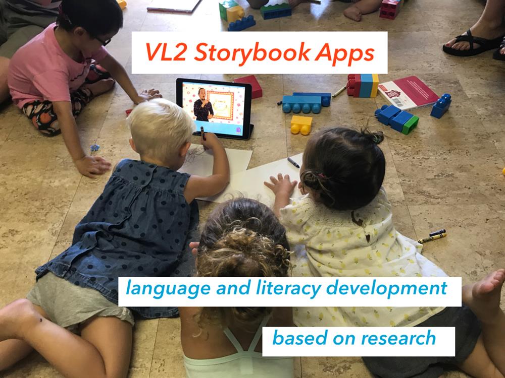 Four children watching a story book video with sign language.