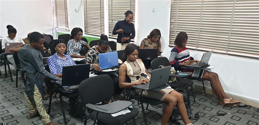 This photo depicts a diverse group of individuals in a modern learning environment, engaged in activities on their laptops. They appear focused and dedicated to their tasks. The presence of both men and women in the room reflects inclusivity and gender equality. The setting suggests a commitment to professional development and the empowerment of individuals through education and technology. The environment seems supportive and conducive to learning, highlighting the importance of providing equal opportunities for personal and professional growth.
