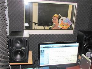 A person in the studio creating audio recordings of children books.