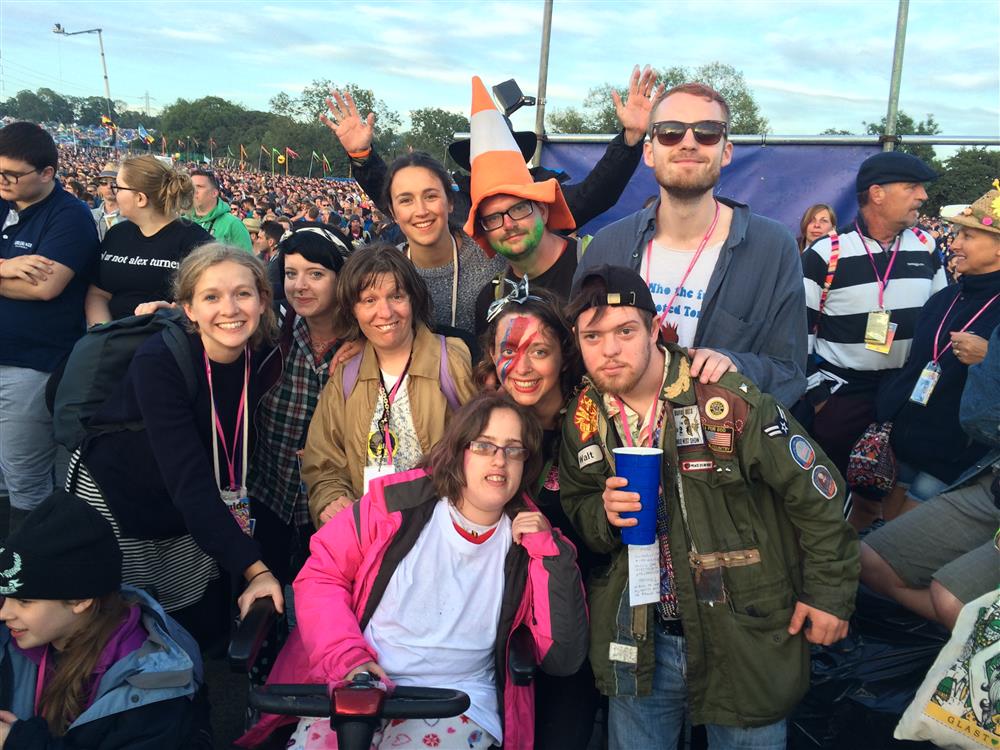 A group picture of the several buddies at a festival.