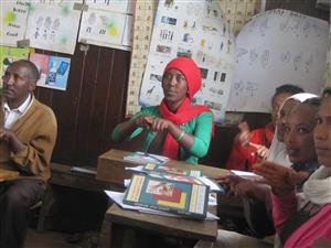  Adults and children communicate in sign language to the teacher, who is outside the picture, during a in-service training for teachers in Debresina.