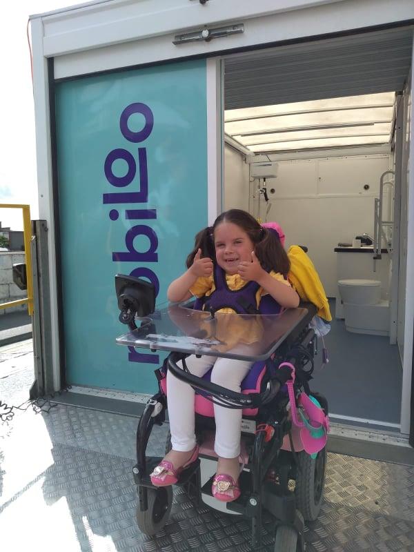 A happy child with physical disabilities thanks to Mobiloo A picture inside the mobile toilet.