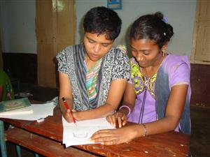 A project participant draws Comics, while being supported by a peer support woman 