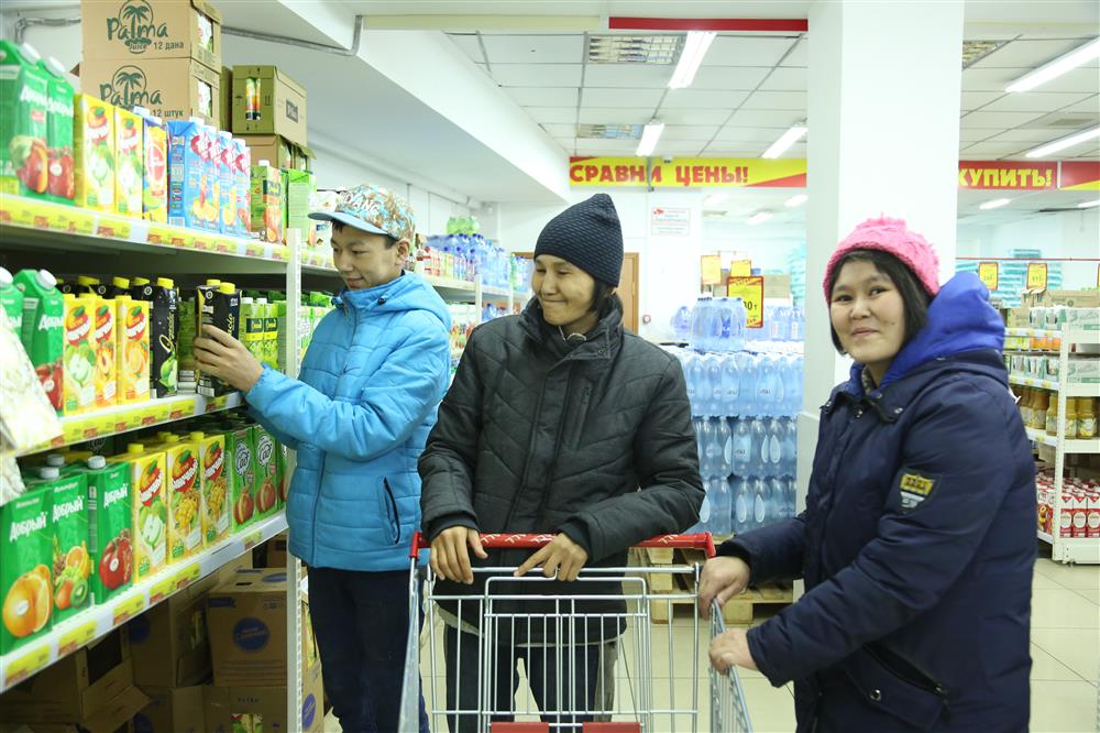 Three persons do weekly grocery shopping by themselves.