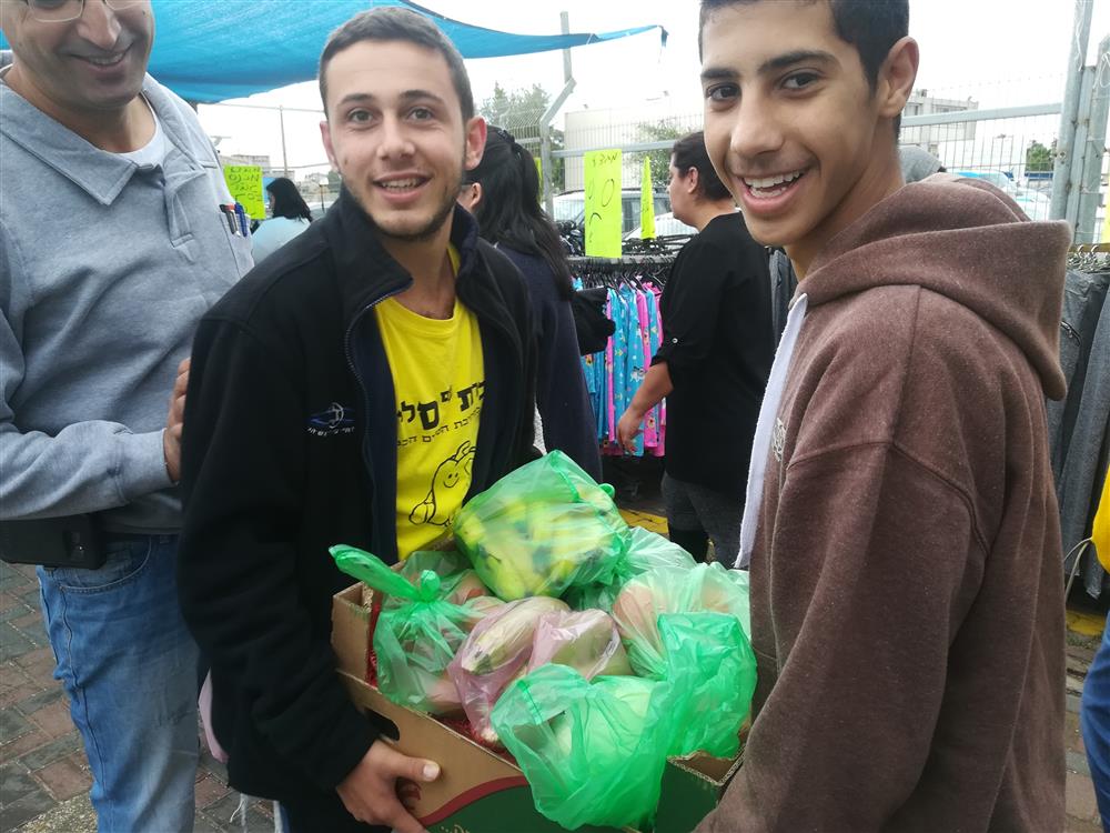 Volunteers helping the elderly carrying bags in the market every Friday.