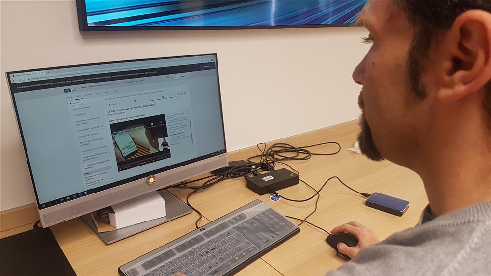 A project participant is looking at the computer screen and taking one of the courses.