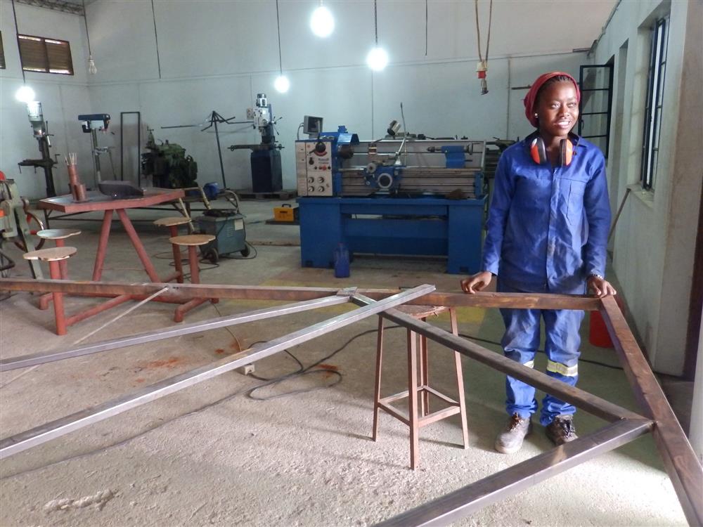 A young woman working on a project in a technical training institution.