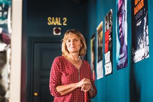 GRETA user opens app in cinema before film begins. A person ready to go to the cinema.